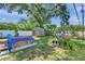 Landscaped backyard features a deck with hot tub, mature trees, storage sheds, and a charming bird bath at 8074 37Th N Ave, St Petersburg, FL 33710