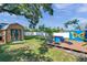 Well-kept backyard with storage shed, seating, a deck with a covered hot tub, and butterfly mural accent at 8074 37Th N Ave, St Petersburg, FL 33710