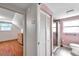 Bathroom featuring white bifold doors, tile floors, window, and toilet at 8074 37Th N Ave, St Petersburg, FL 33710