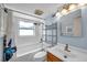 Bright bathroom featuring white tile, a shower-tub combo, and a modern vanity at 8074 37Th N Ave, St Petersburg, FL 33710