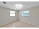 Clean and well-lit bedroom featuring tile floors and two windows at 8074 37Th N Ave, St Petersburg, FL 33710