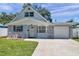 Charming one-story home with stone accents, a garage and a well-manicured lawn at 8074 37Th N Ave, St Petersburg, FL 33710
