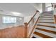Bright and inviting entry foyer with hardwood floors and a staircase leading to the upper level at 8074 37Th N Ave, St Petersburg, FL 33710