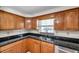 Open Kitchen area features stone countertops, wood cabinetry and modern appliances at 8074 37Th N Ave, St Petersburg, FL 33710