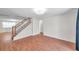 Open living area with wood flooring, a staircase, and view into another room at 8074 37Th N Ave, St Petersburg, FL 33710