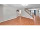 Open living area with wood flooring, a staircase, and view into other rooms at 8074 37Th N Ave, St Petersburg, FL 33710