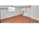 Living room with wood floors and a staircase at 8074 37Th N Ave, St Petersburg, FL 33710