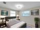 Comfortable bedroom with a padded headboard, two side tables and an art deco ceiling fan at 8074 37Th N Ave, St Petersburg, FL 33710