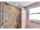 Walk-in shower features custom tile work, dual shower heads and upgraded fixtures at 8074 37Th N Ave, St Petersburg, FL 33710