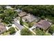 Beautiful aerial view of a home with a screened pool and lush landscaping in a desirable neighborhood at 9242 Brindlewood Dr, Odessa, FL 33556