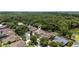 Expansive aerial showcasing the property nestled among mature trees in a serene and private setting at 9242 Brindlewood Dr, Odessa, FL 33556