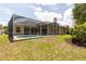 Picture of backyard featuring screened-in pool, patio, lush lawn, and mature trees at 9242 Brindlewood Dr, Odessa, FL 33556