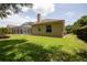 Expansive backyard with lush green grass, patio space, and refreshing pool at 9242 Brindlewood Dr, Odessa, FL 33556
