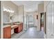 Primary bathroom with dual sinks, soaking tub, and walk-in shower at 9242 Brindlewood Dr, Odessa, FL 33556