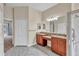 Bathroom with dual vanities, tile flooring, and a separate shower at 9242 Brindlewood Dr, Odessa, FL 33556