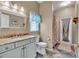 Bright bathroom with updated vanity, granite countertop, and decorative mirror at 9242 Brindlewood Dr, Odessa, FL 33556