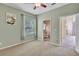 Bedroom with connected bathroom, plush carpet, and scenic backyard view at 9242 Brindlewood Dr, Odessa, FL 33556