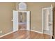 Open bedroom with hardwood floors and entrance to other rooms at 9242 Brindlewood Dr, Odessa, FL 33556