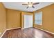Comfortable bedroom featuring wood-look flooring, ample closet space, and a ceiling fan at 9242 Brindlewood Dr, Odessa, FL 33556