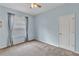 Cozy bedroom with neutral carpet, ceiling fan, and light blue walls providing a calming atmosphere at 9242 Brindlewood Dr, Odessa, FL 33556