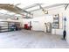 Spacious garage with overhead storage racks, shelving, and tool storage perfect for organization and projects at 9242 Brindlewood Dr, Odessa, FL 33556