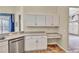 Bright corner of kitchen with ample counter space, stainless dishwasher, and adjacent breakfast nook at 9242 Brindlewood Dr, Odessa, FL 33556