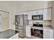 Modern kitchen featuring stainless steel appliances, including refrigerator, range, and microwave at 9242 Brindlewood Dr, Odessa, FL 33556