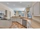 Spacious kitchen features white cabinets, island, stainless steel appliances, and open layout at 9242 Brindlewood Dr, Odessa, FL 33556
