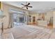 Spacious living room showcasing sliding glass doors to the lanai and open layout to kitchen at 9242 Brindlewood Dr, Odessa, FL 33556