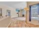 Open-concept living room with fireplace, tile flooring, and access to kitchen at 9242 Brindlewood Dr, Odessa, FL 33556