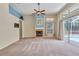 Bright living room featuring a fireplace, ceiling fan, and sliding door to the pool area at 9242 Brindlewood Dr, Odessa, FL 33556