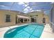 Sparkling swimming pool and screened-in enclosure creating a private outdoor oasis at 9242 Brindlewood Dr, Odessa, FL 33556