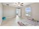 Room featuring neutral-colored tile floors, access to the backyard, and a large window with blinds at 9437 Lemon Drop Loop, Sun City Center, FL 33573