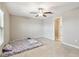 Room featuring neutral-colored tile floors, a large window with blinds, and overhead fan at 9437 Lemon Drop Loop, Sun City Center, FL 33573