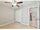 Cozy bedroom with neutral walls, double door closet, and ceiling fan at 9437 Lemon Drop Loop, Sun City Center, FL 33573