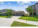 Inviting single-story home with well-kept lawn and a two-car garage at 9437 Lemon Drop Loop, Sun City Center, FL 33573