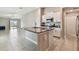 Open-concept kitchen featuring a granite island and stainless steel appliances at 9437 Lemon Drop Loop, Sun City Center, FL 33573