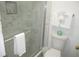 Modern bathroom with glass shower, tile surround, and toilet with neatly folded towels at 9980 Gulf Blvd # 408, Treasure Island, FL 33706