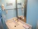 Bathroom featuring an elegant mirror, modern sink, and decorative 'Happy' lettering on a light blue wall at 9980 Gulf Blvd # 408, Treasure Island, FL 33706