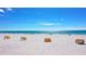 Beautiful beach view with white sand and clear blue water and beach cabanas for a relaxing day at 9980 Gulf Blvd # 408, Treasure Island, FL 33706