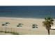 Expansive beach view showing pristine white sand and turquoise waters, with beach chairs at 9980 Gulf Blvd # 408, Treasure Island, FL 33706