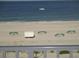 Close-up view of the beach featuring sunshades at 9980 Gulf Blvd # 408, Treasure Island, FL 33706