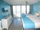 Inviting bedroom with two beds and balcony access, providing serene views and ample natural light at 9980 Gulf Blvd # 408, Treasure Island, FL 33706