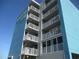 Exterior view of Island Inn featuring multiple levels of balconies and a modern design at 9980 Gulf Blvd # 408, Treasure Island, FL 33706