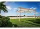 Green lawn with beach pergola near beach with volleyball net and beautiful ocean views at 9980 Gulf Blvd # 408, Treasure Island, FL 33706