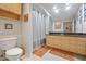 Functional bathroom featuring a toilet, single vanity, and shower with frosted glass at 100 4Th S Ave # 103, St Petersburg, FL 33701