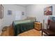 Simple bedroom features comfortable bed, side table, and wood-look flooring at 100 4Th S Ave # 103, St Petersburg, FL 33701
