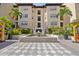 Beautiful condo building with a decorative water fountain and lush, tropical landscaping at 100 4Th S Ave # 103, St Petersburg, FL 33701
