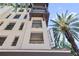 Beautiful condo building exterior with balconies, blue sky, and palm trees at 100 4Th S Ave # 103, St Petersburg, FL 33701