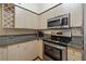 Well-equipped kitchen with granite counters, and stainless steel appliances at 100 4Th S Ave # 103, St Petersburg, FL 33701